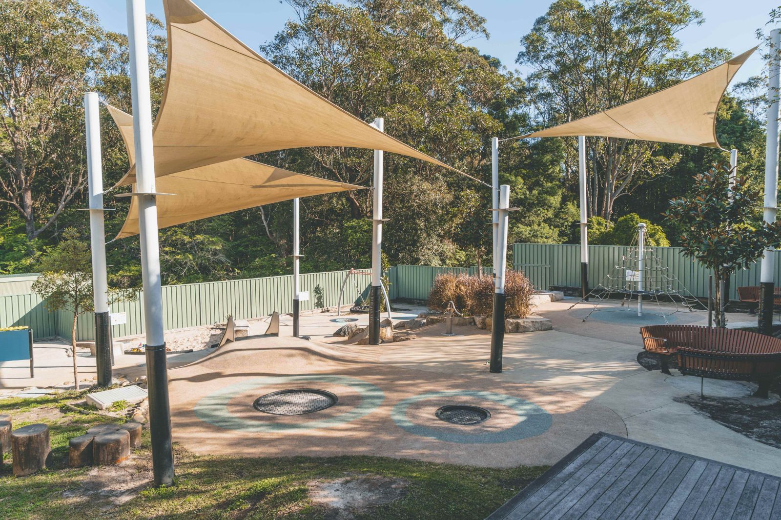 Outdoor play area with natural elements and seating